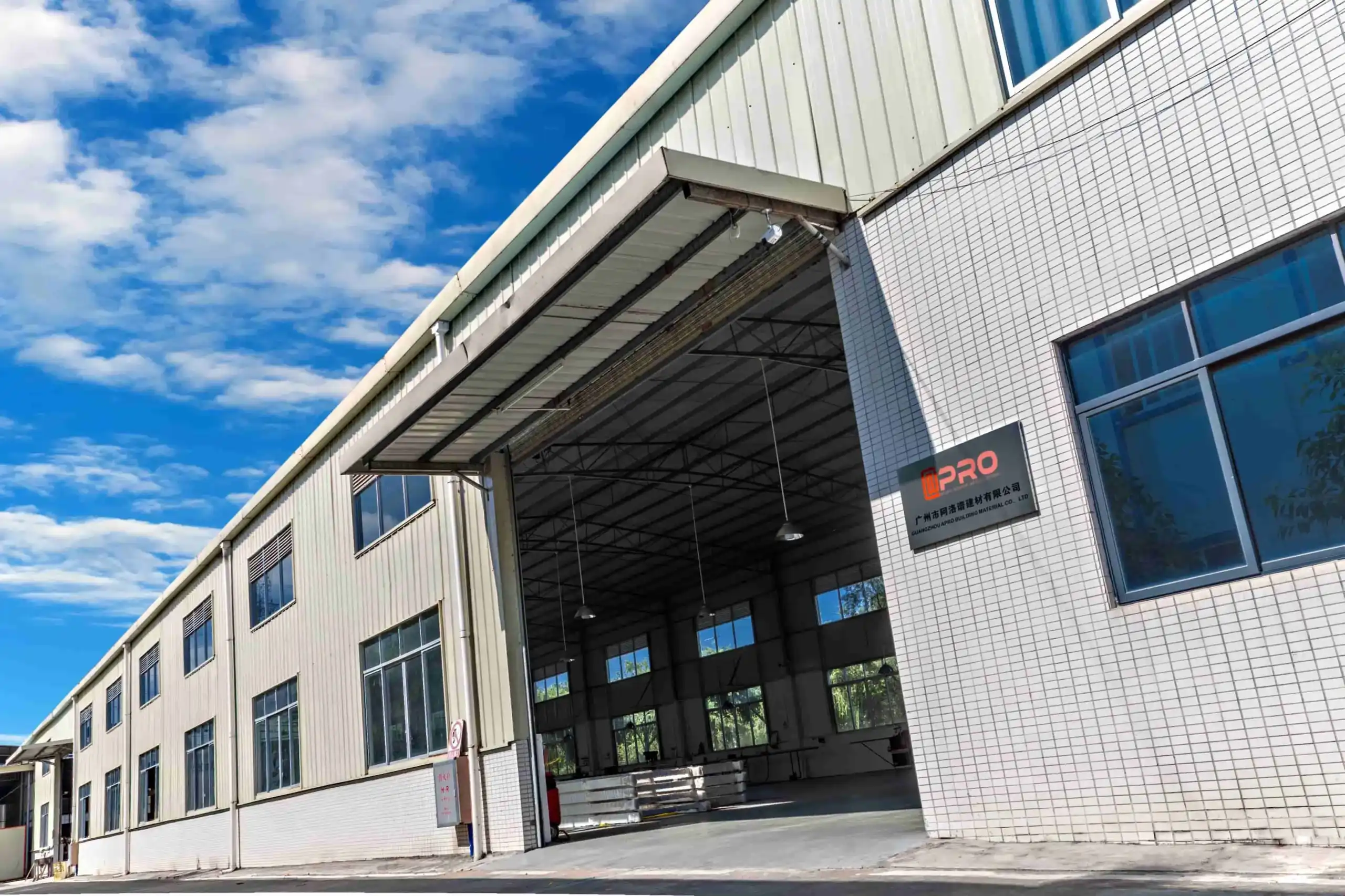 APRO factory exterior with aluminum windows under a clear sky