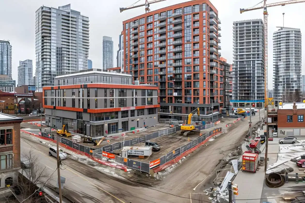Large construction site surrounded by tall buildings