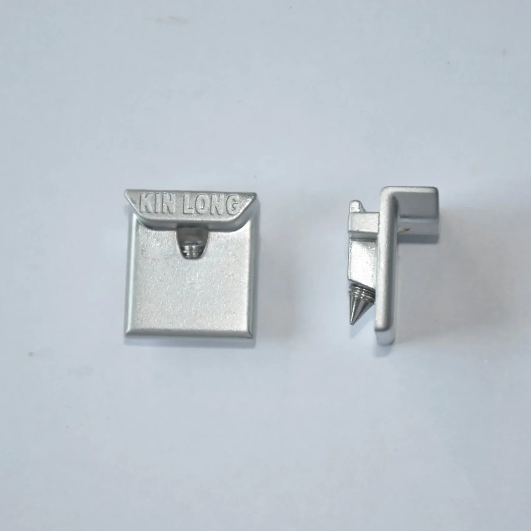 Two pieces of an aluminum door locking mechanism