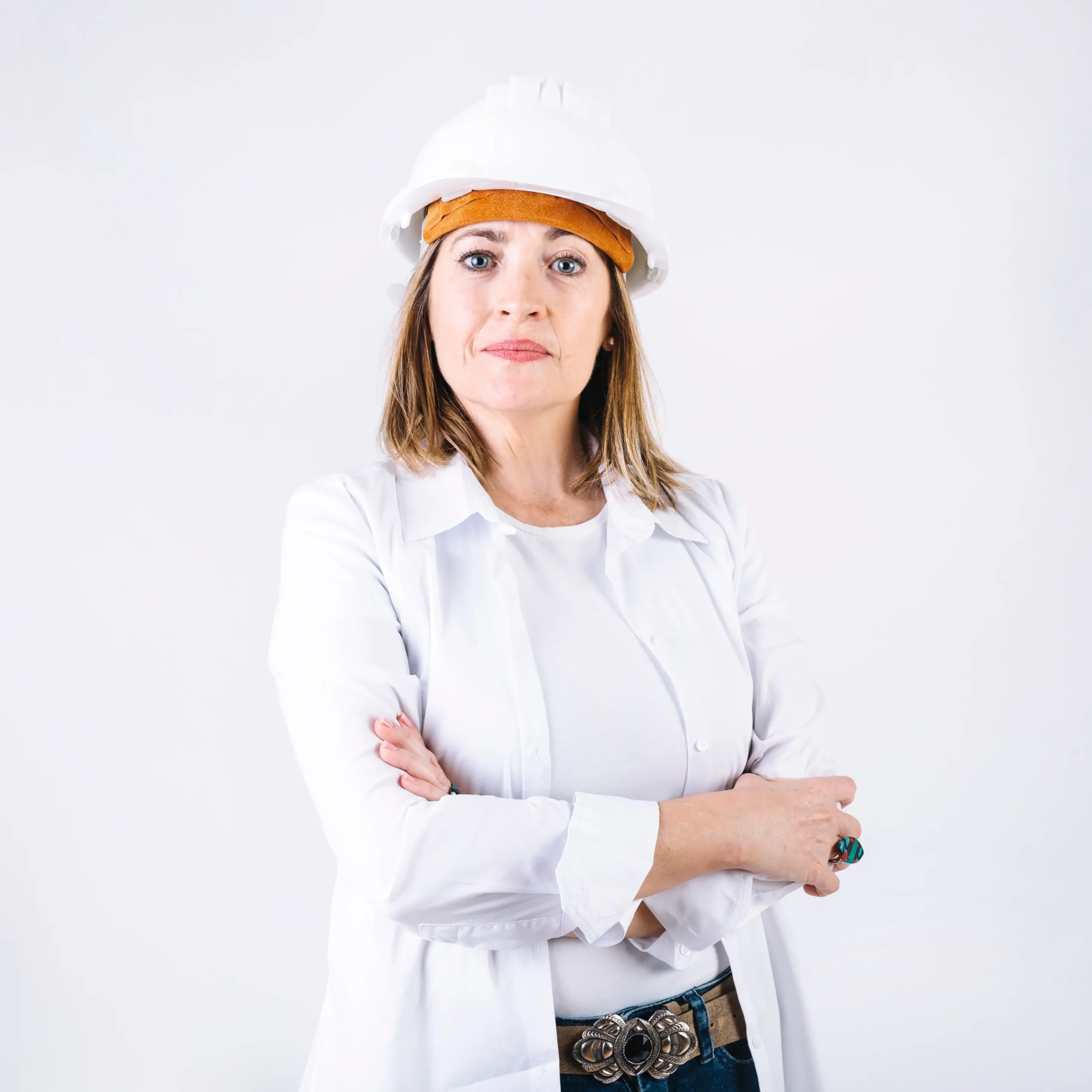 Woman wearing hard hat crossing arms confidently