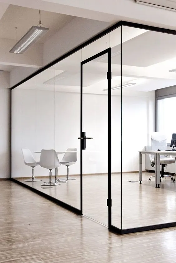 Frameless Glass Partition enclosing a minimalist office space
