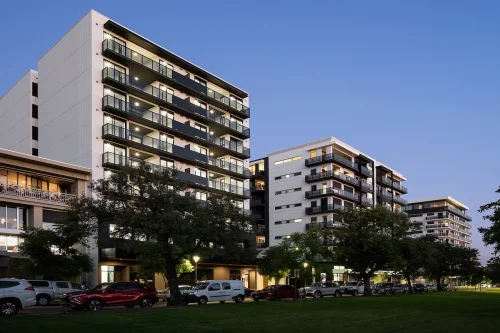 HurtleCo modern apartment buildings with balconies at dusk