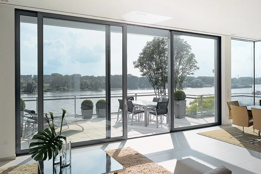 Large sliding glass doors opening to a scenic balcony