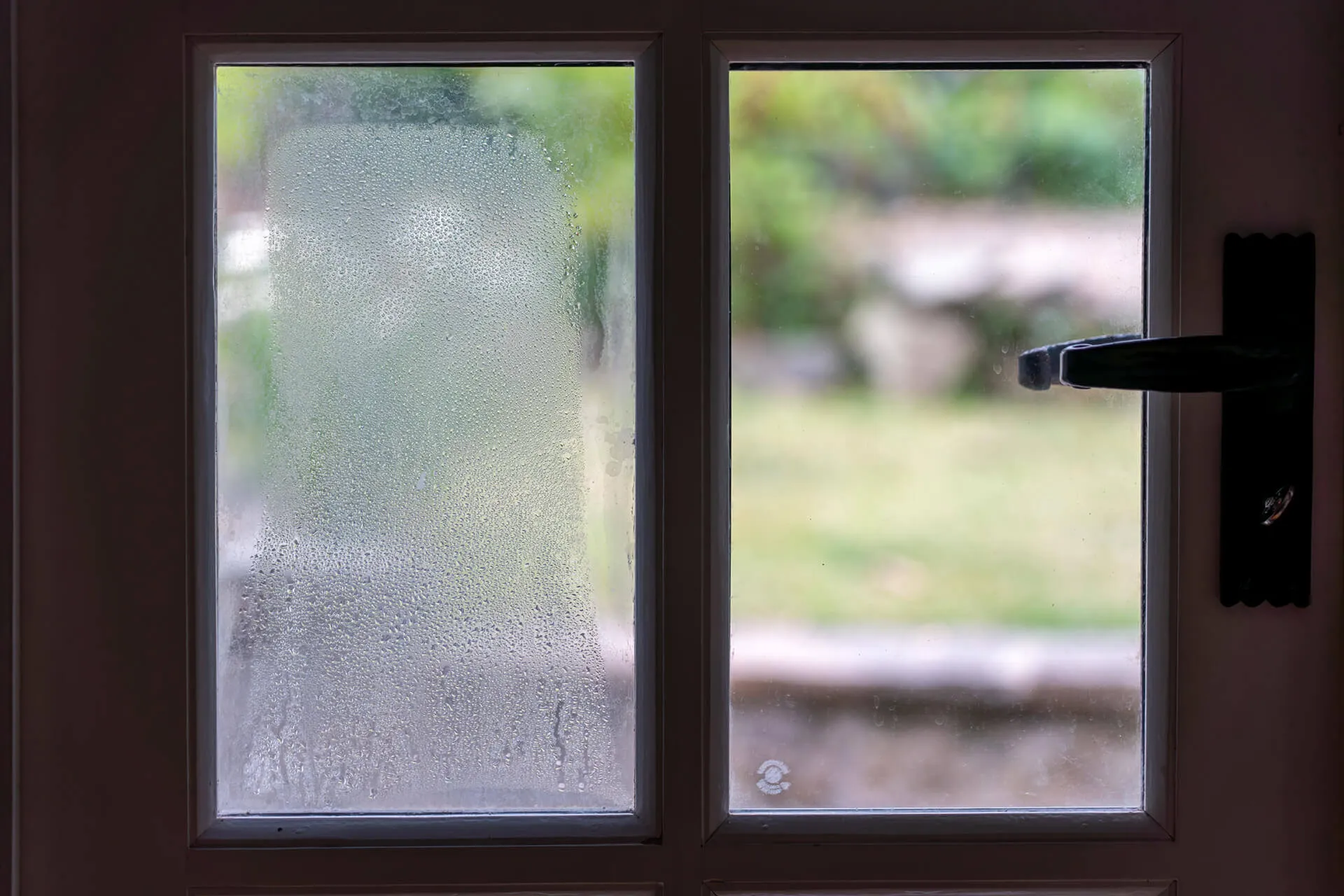 Condensation and fog on glass panels of a front door