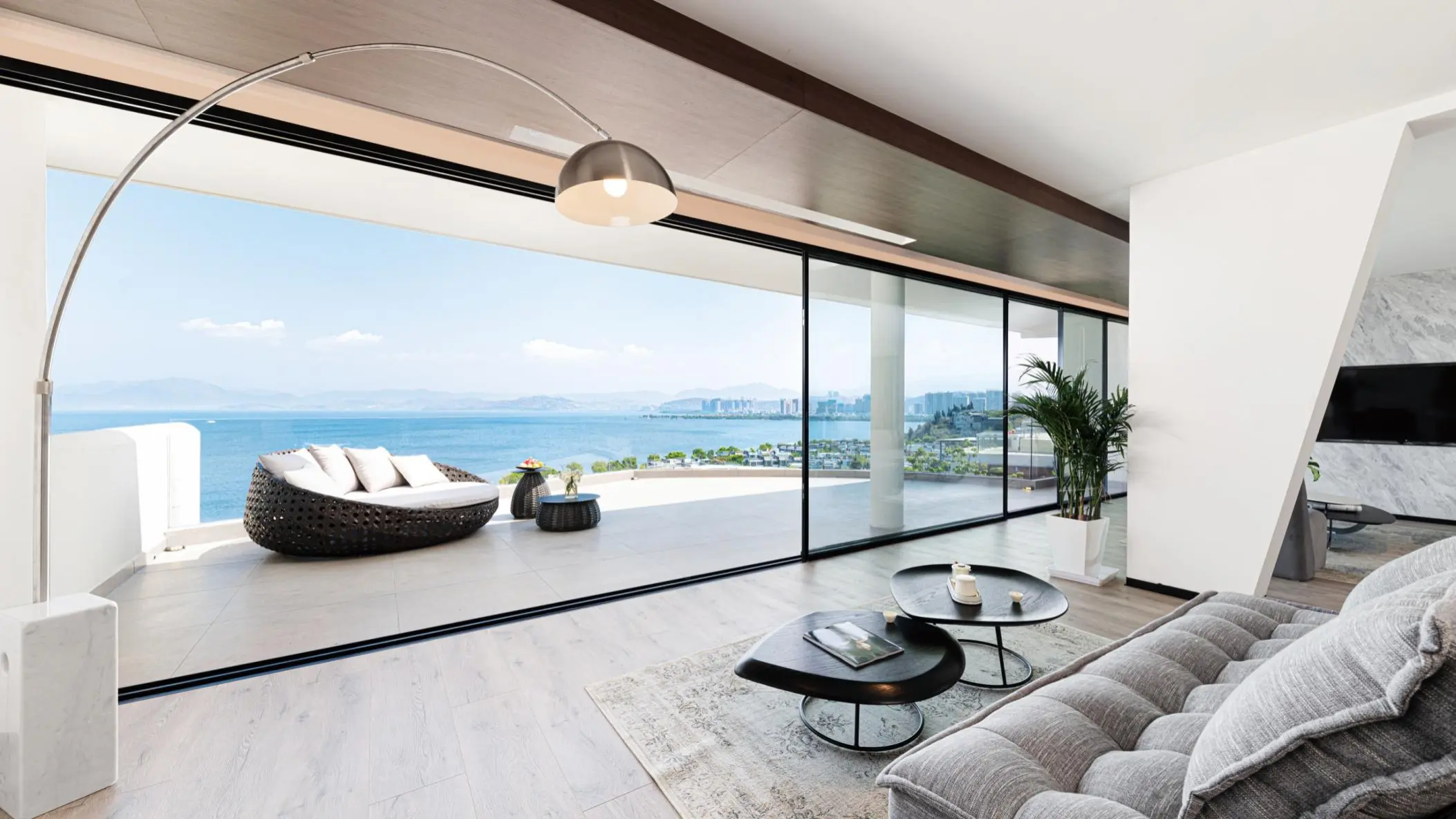 Luxury living room with full glass ocean view sliding doors