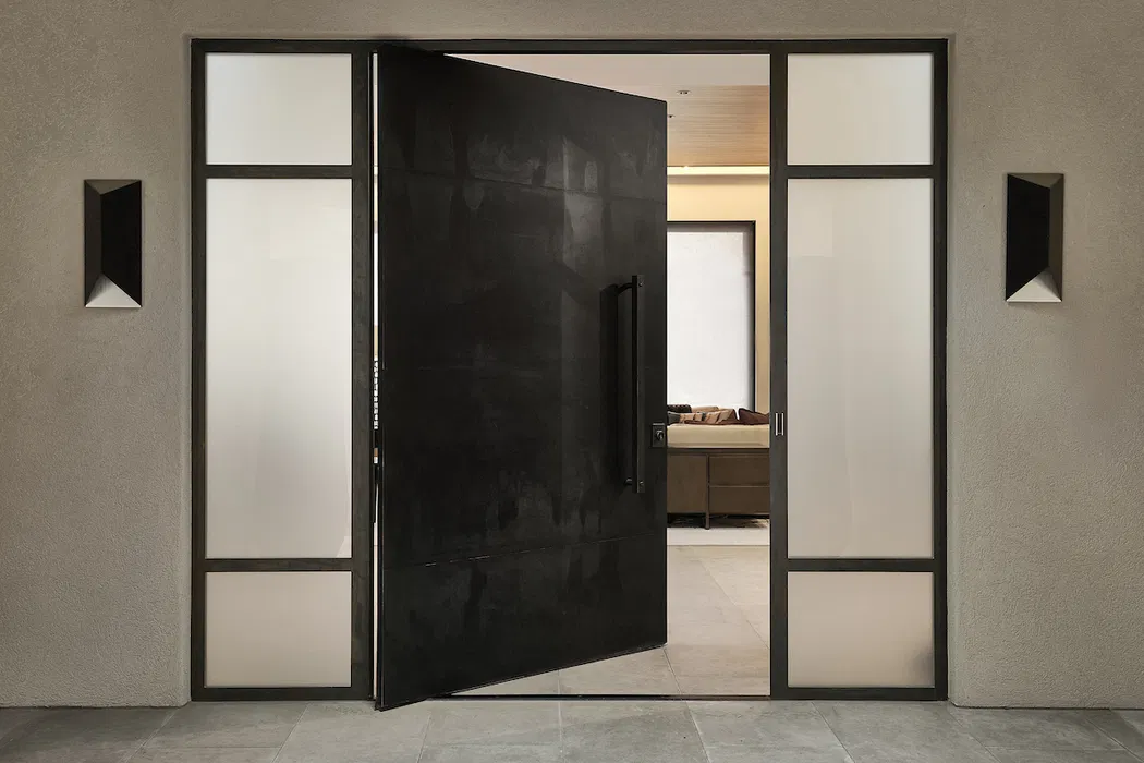 Modern black pivot door opening to reveal interior space