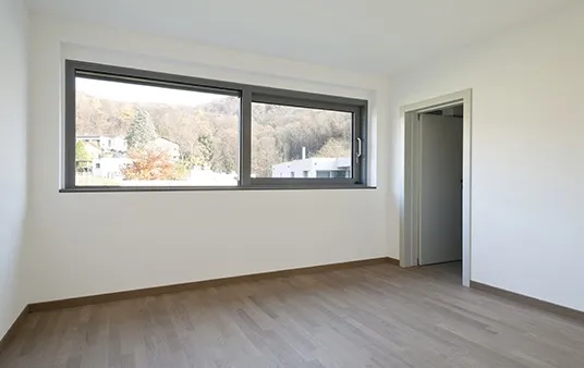 Sliding window placed high on wall in modern empty room