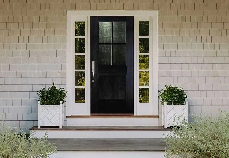Black front door with glass panels and white trim