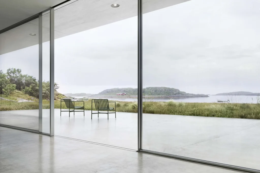 Frameless sliding door with scenic lakeside view