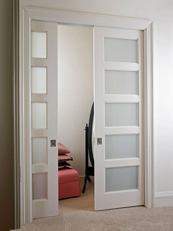 Frosted glass panel pocket doors in bedroom