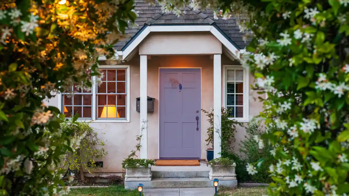 Lavender front door with evening porch light