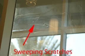 Scratches on Low E glass surface close up
