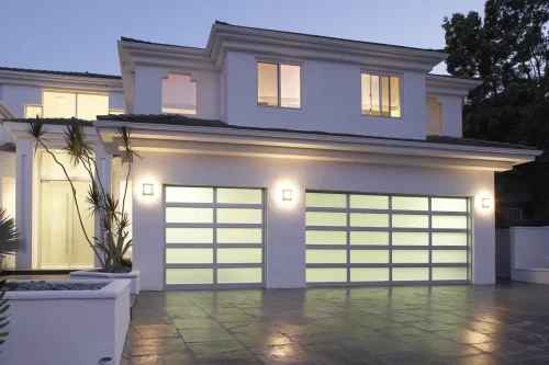 Modern white house with three frosted glass garage doors