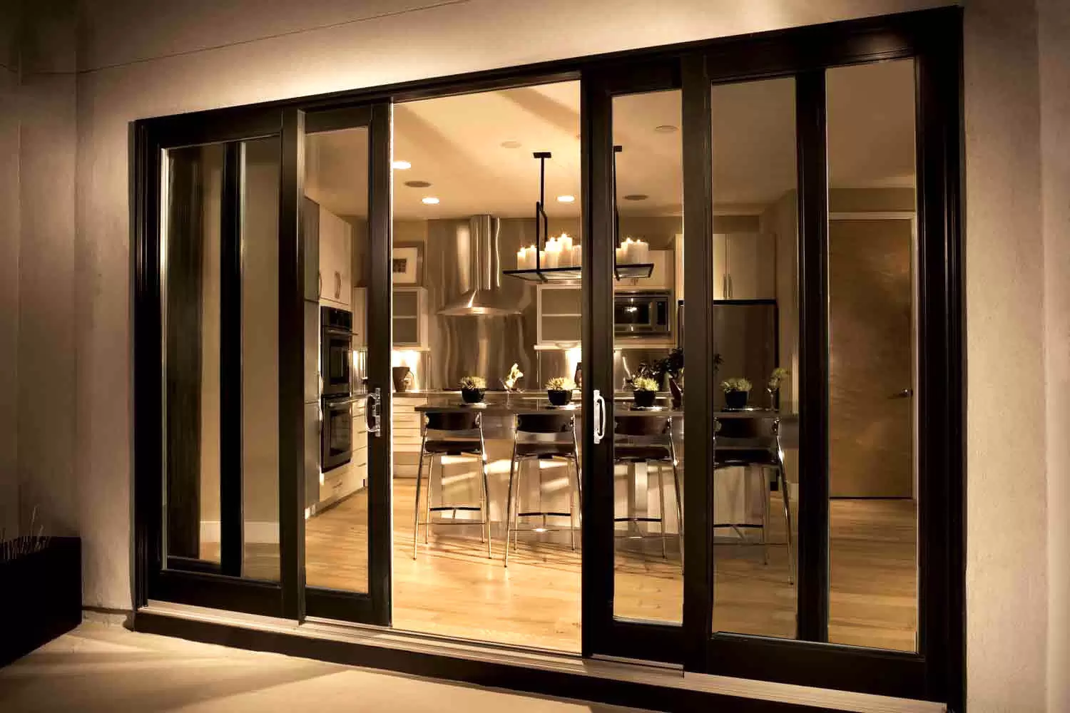 Multi panel sliding aluminum glass door at night