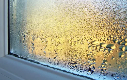 Close up of window condensation with sunlight glow