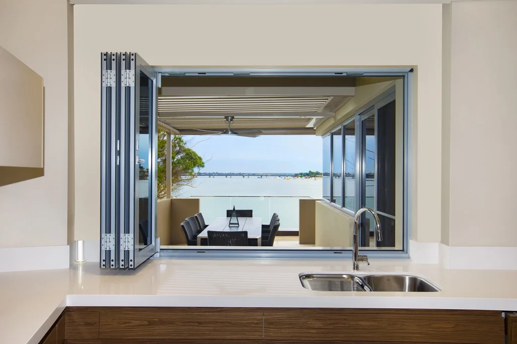 Kitchen bifold window connecting to outdoor dining area