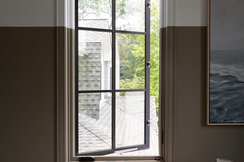 Single casement window open to outdoor view