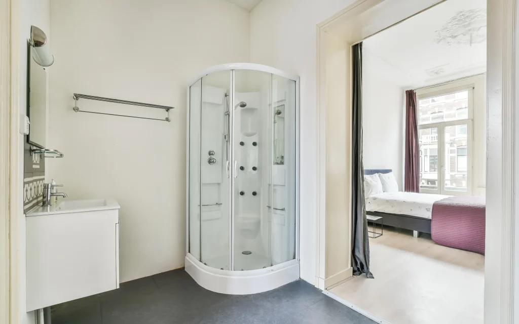 Bathroom with curved glass corner shower enclosure