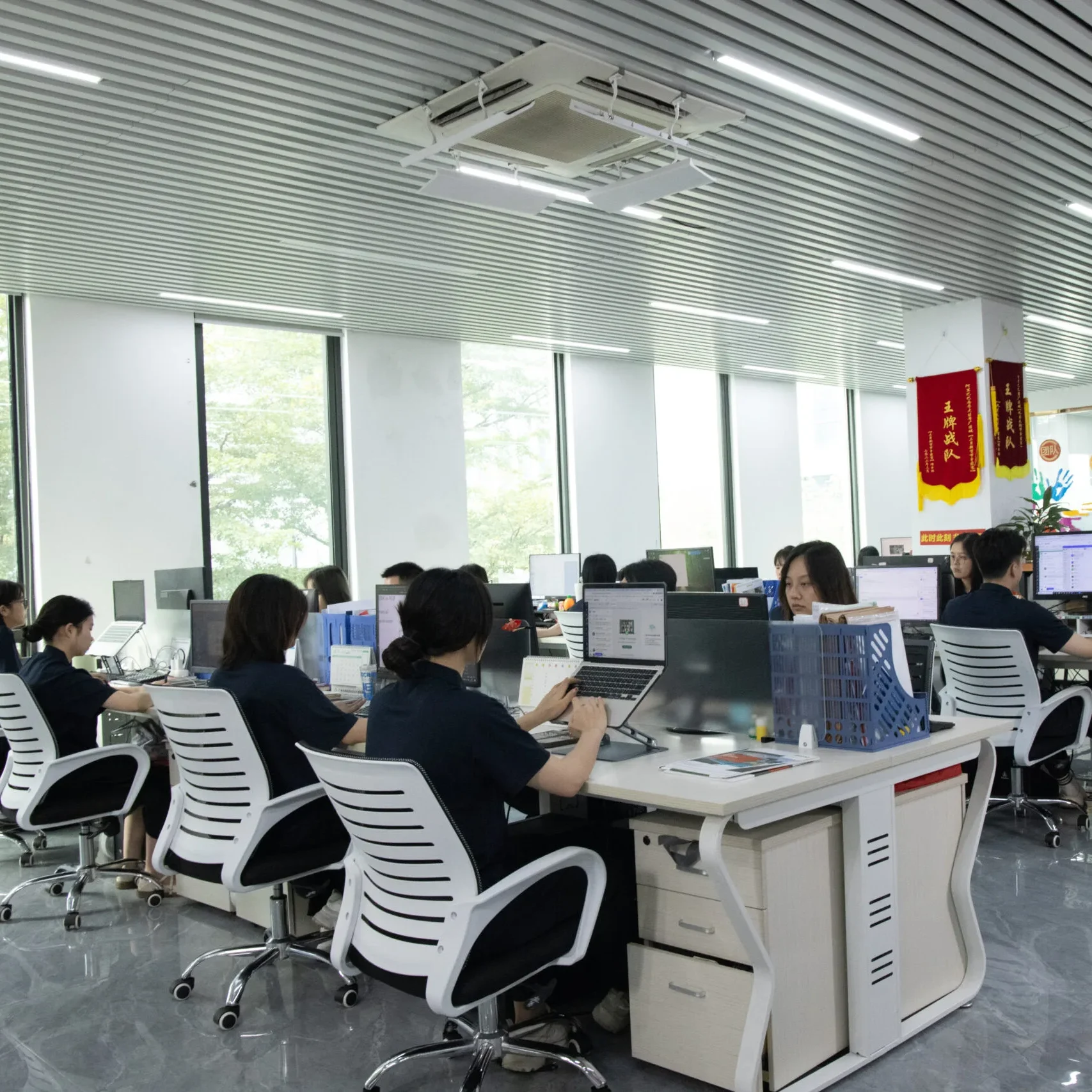 APRO customer service team working in modern open office space