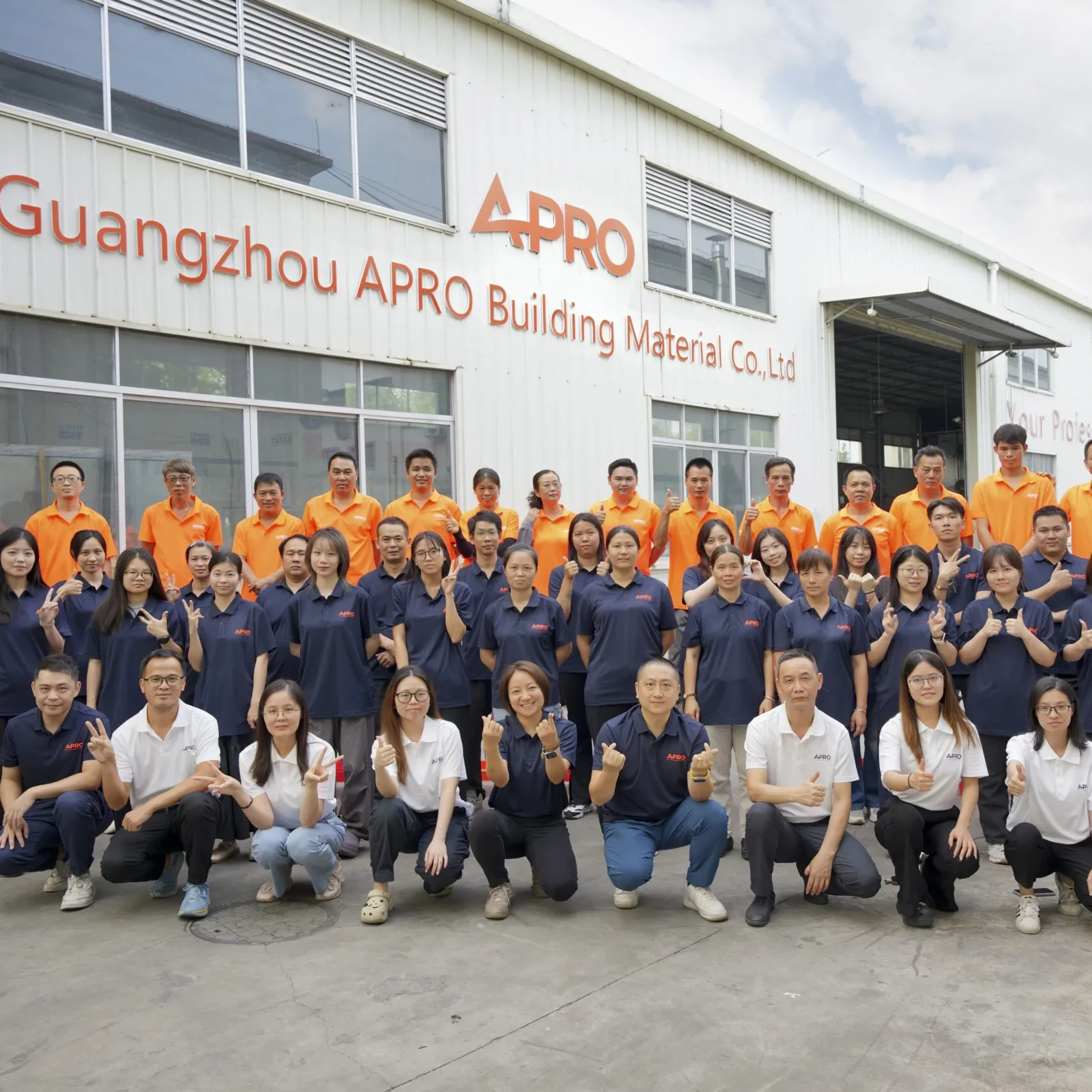 APRO production team in front of factory building in Guangzhou