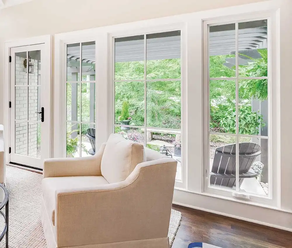White casement windows beside interior French doors