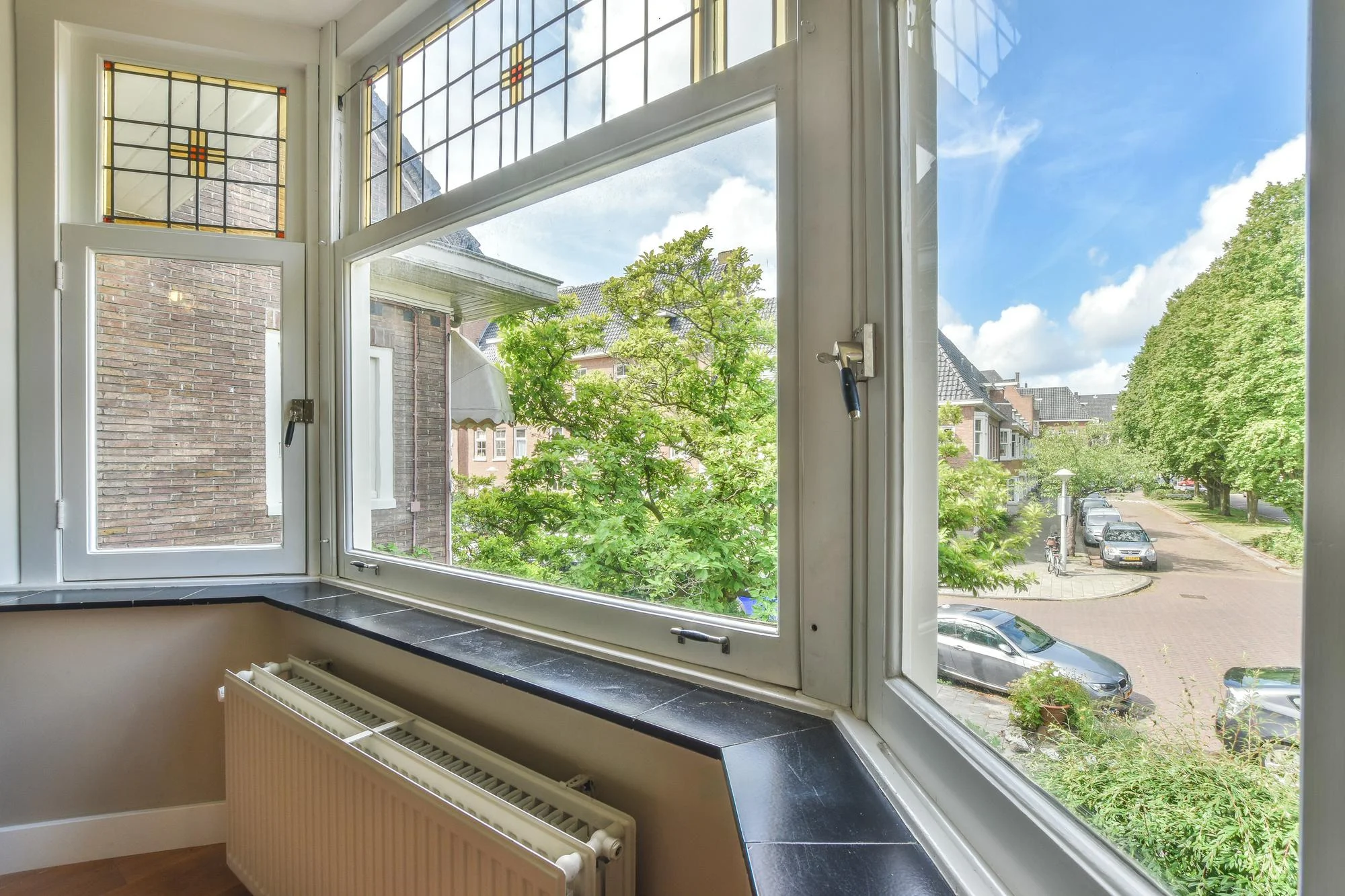 Casement window opened outward with street view