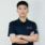 Qi Team member in navy APRO polo with arms crossed