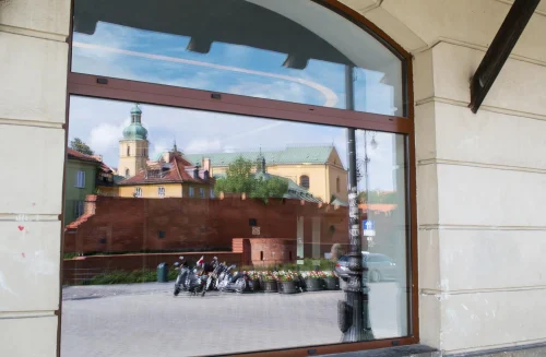 Shopfront window glass reflecting urban architecture