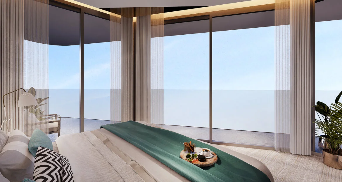 Dormitorio con vistas al mar y puertas corredizas de vidrio en The One Nai Harn