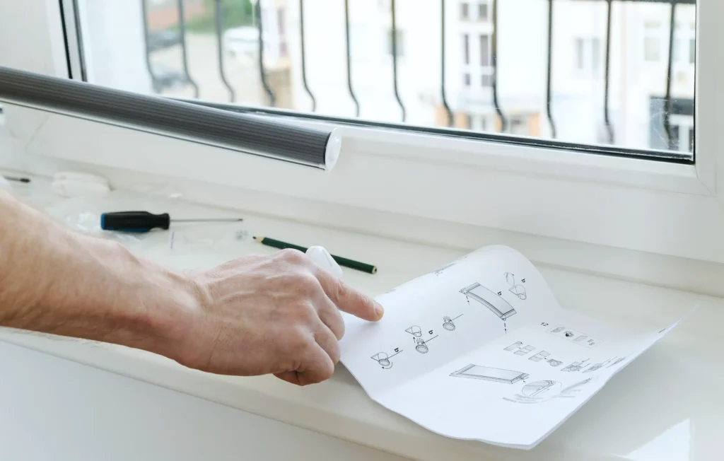 man s hand with instruction installing window