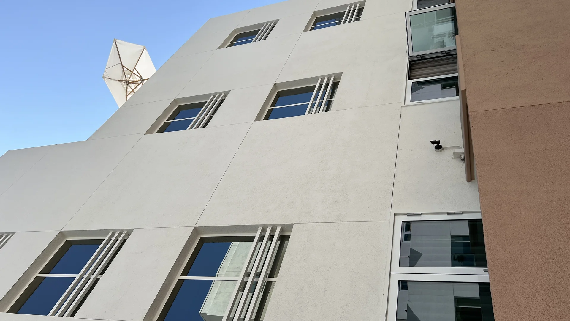 Custom APRO A80T thermally broken balcony swing doors installed on hotel guestroom terrace